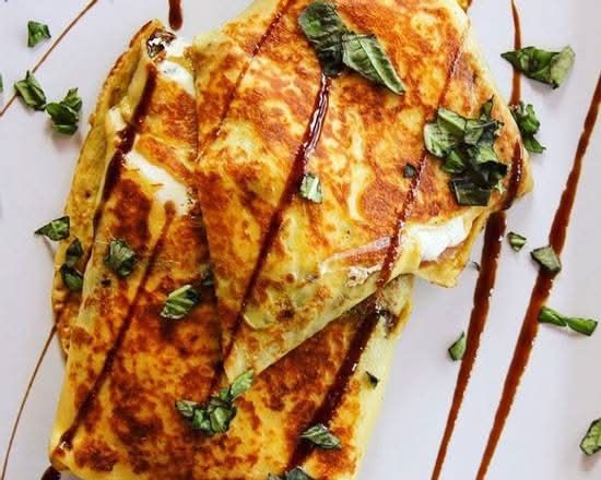 Tuscany Crepe. Mozzarella, imported prosciutto, house pesto, balsamic glaze, & fresh tomatoes